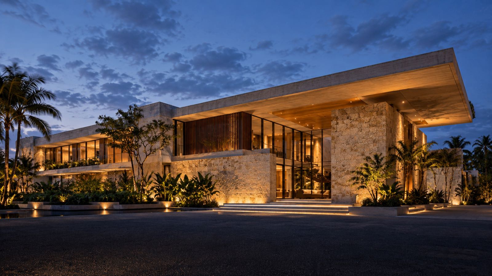 Residencia contemporánea de piedra y concreto iluminada al anochecer